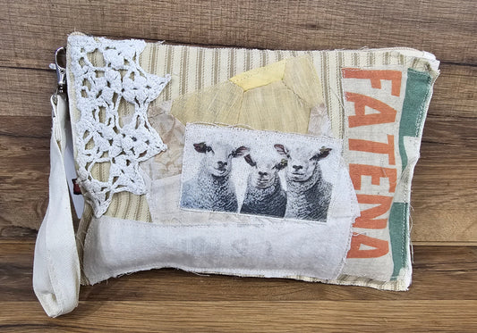 Allen's Bootery handmade fabric wristlet featuring a sheep print, lace detail, and zippered top closure.