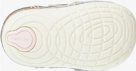 Allen's Bootery Jazzy infant sneaker showing the cream-colored rubber outsole with deep flex grooves and pink logo