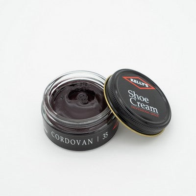 Allen's Bootery Kelly's cordovan leather shoe cream in an open glass jar with a black lid for restoring leather.