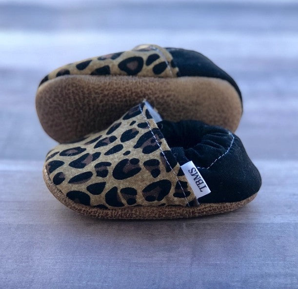 Allen's Bootery leopard print infant moccasin slippers with soft soles and black heel detail