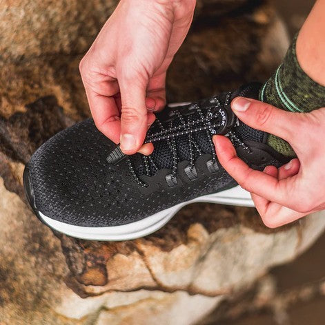 Allen's Bootery LOCK LACES black elastic no-tie shoelaces being adjusted on a running shoe