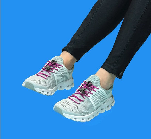 Allen's Bootery Xpand magenta elastic quick release laces installed on grey athletic sneakers