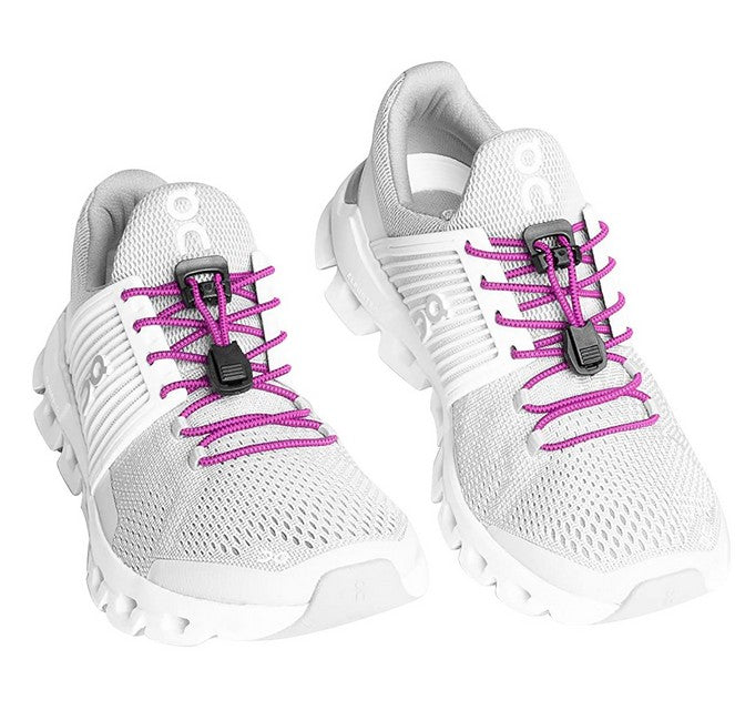Allen's Bootery Xpand magenta elastic quick release laces installed on white athletic sneakers with locking anchors