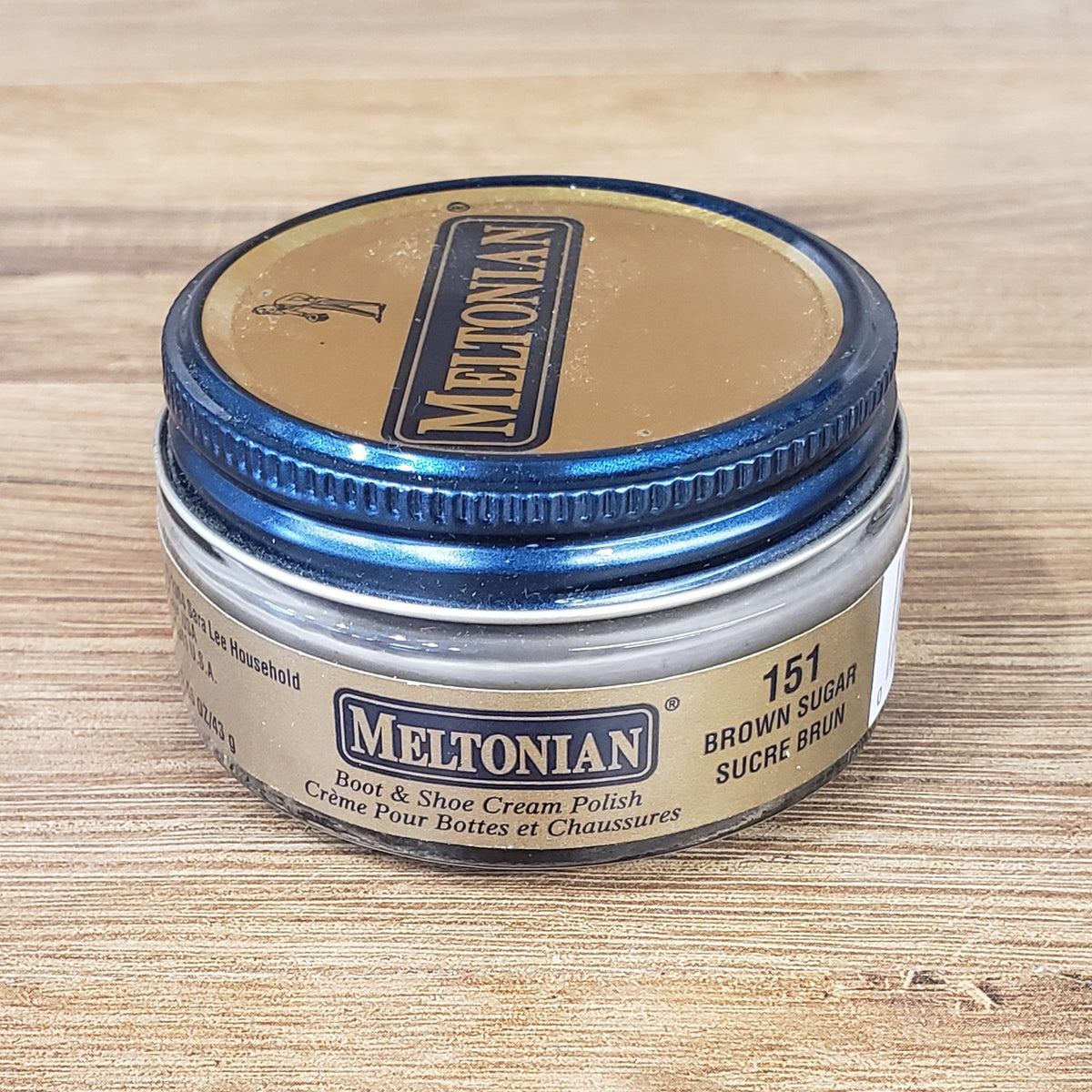 Allen's Bootery Meltonian Brown Sugar boot and shoe cream polish in a small glass jar with a blue metal lid