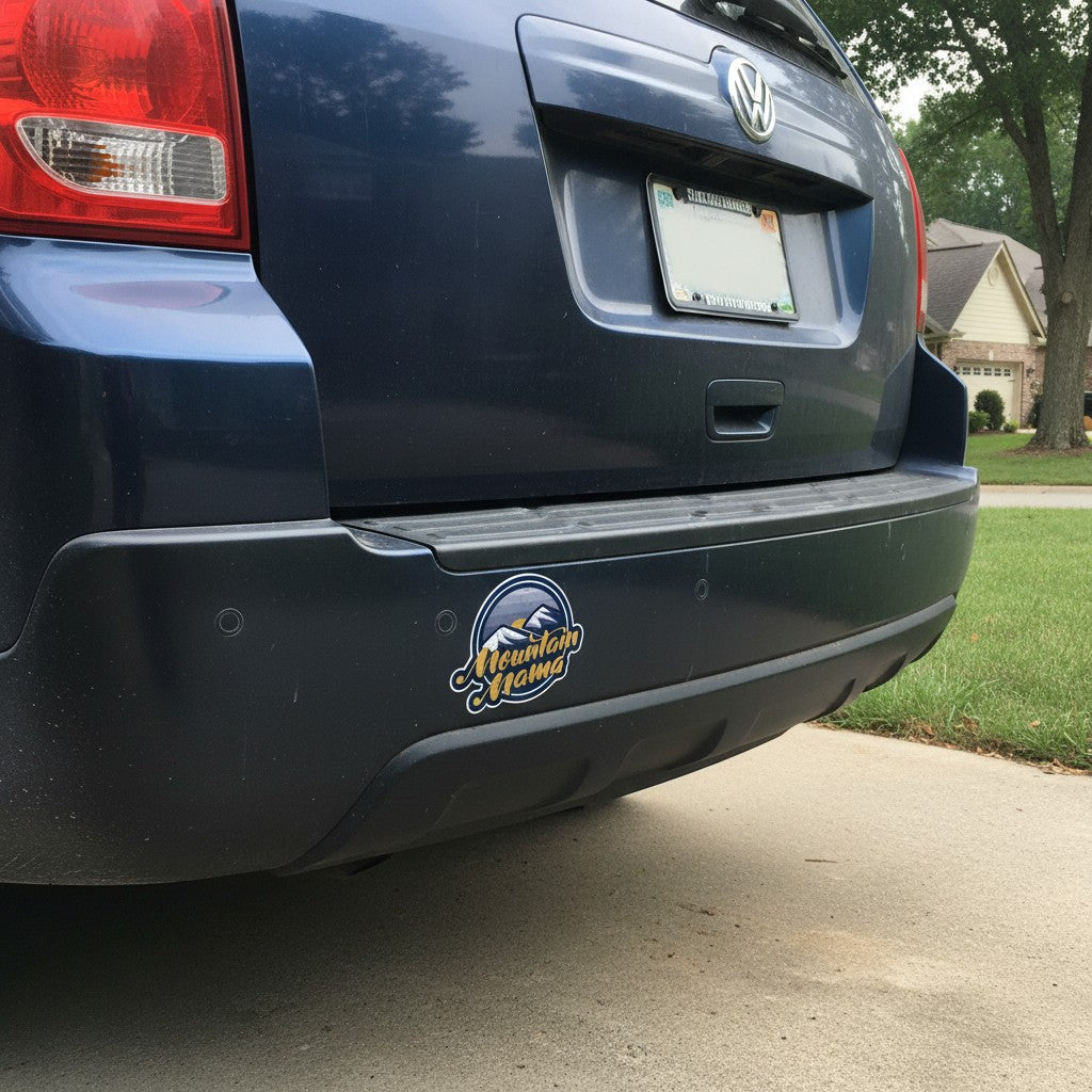 Allen's Bootery Mountain Mama vinyl sticker featuring a mountain sunset design on a dark blue car bumper