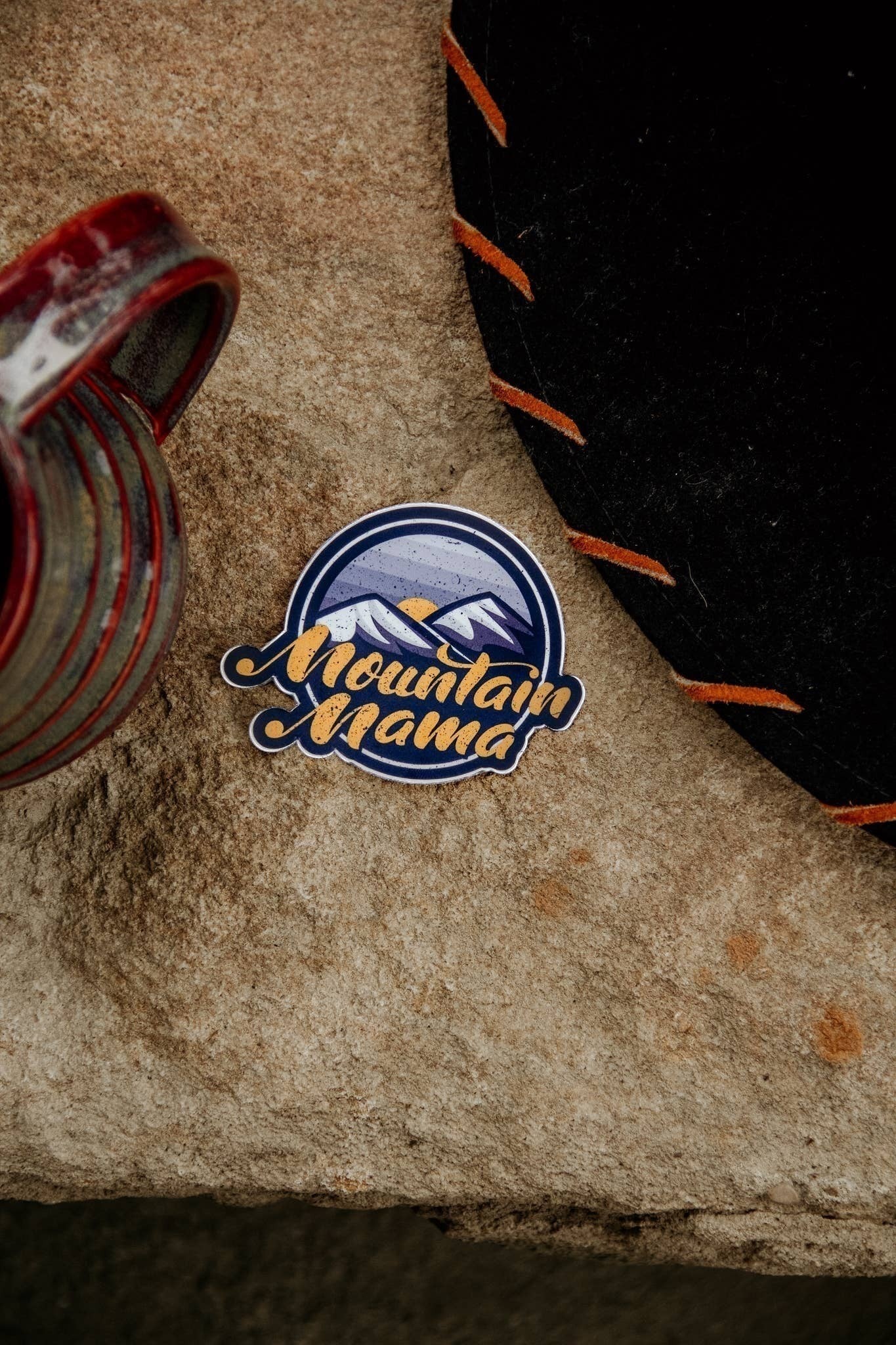 Allen's Bootery Mountain Mama sticker featuring a mountain landscape and sun, weather and UV resistant vinyl decal.