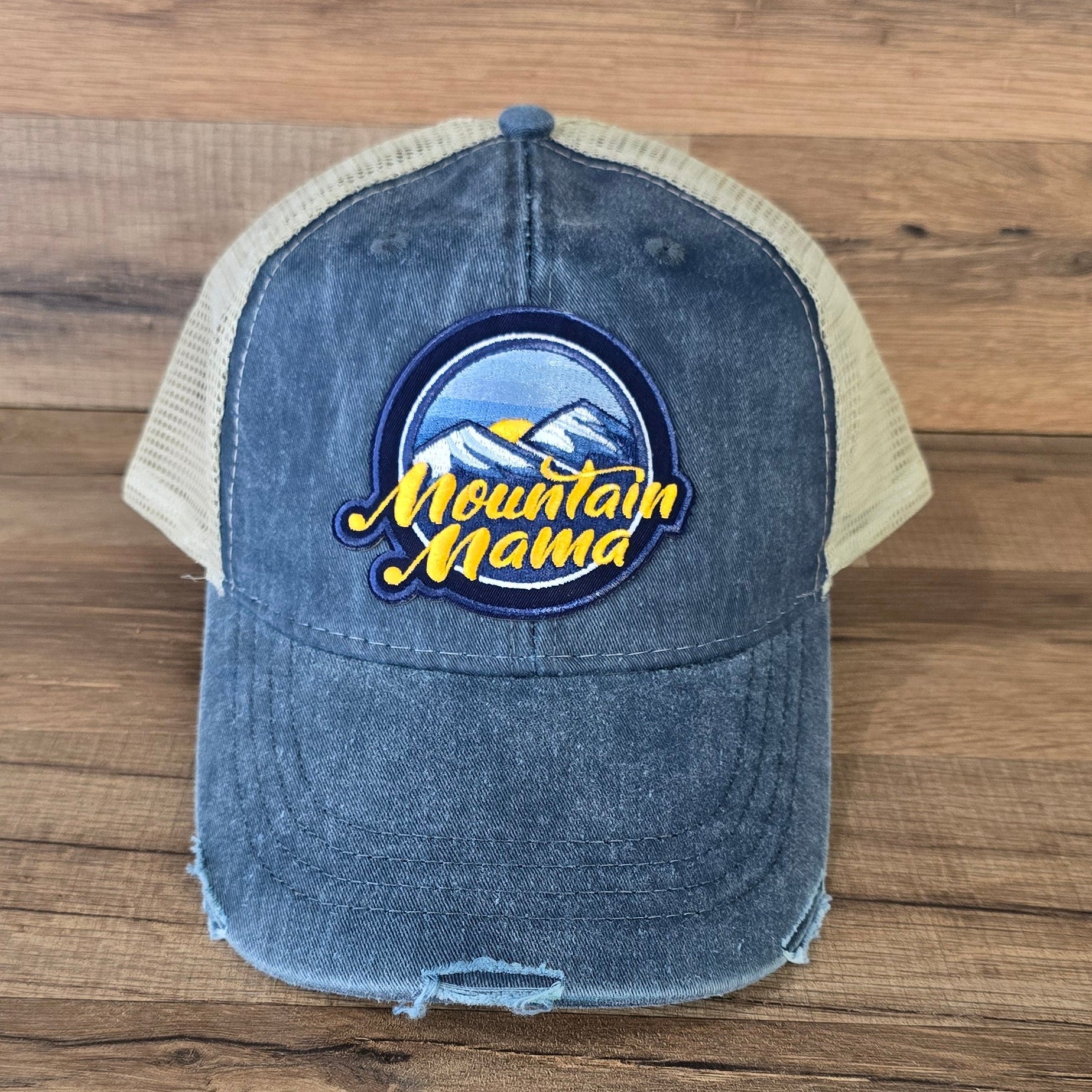 Allen's Bootery distressed blue trucker hat with a Mountain Mama embroidered mountain landscape patch and mesh back