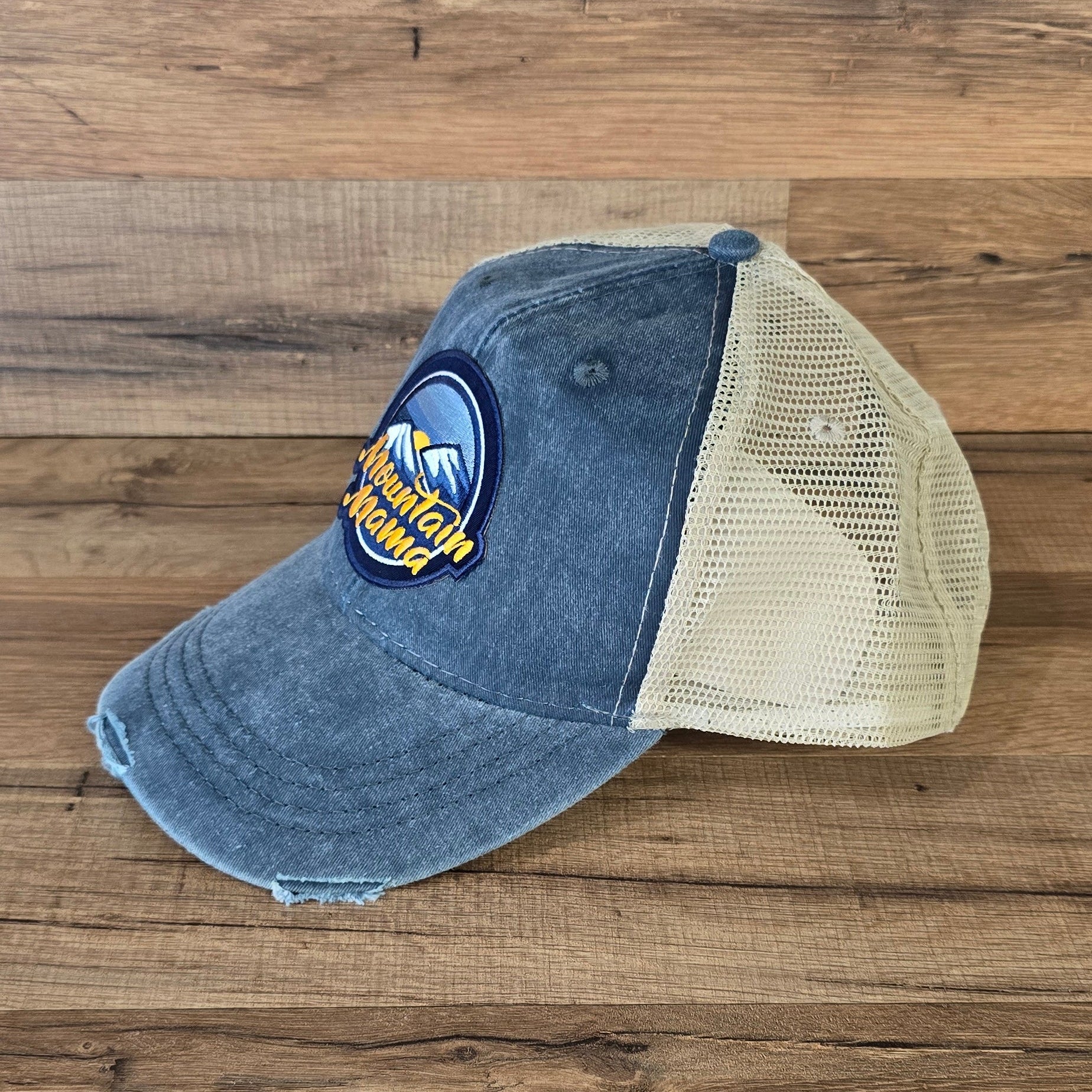 Allen's Bootery Mountain Mama trucker hat with distressed blue denim brim and breathable beige mesh back