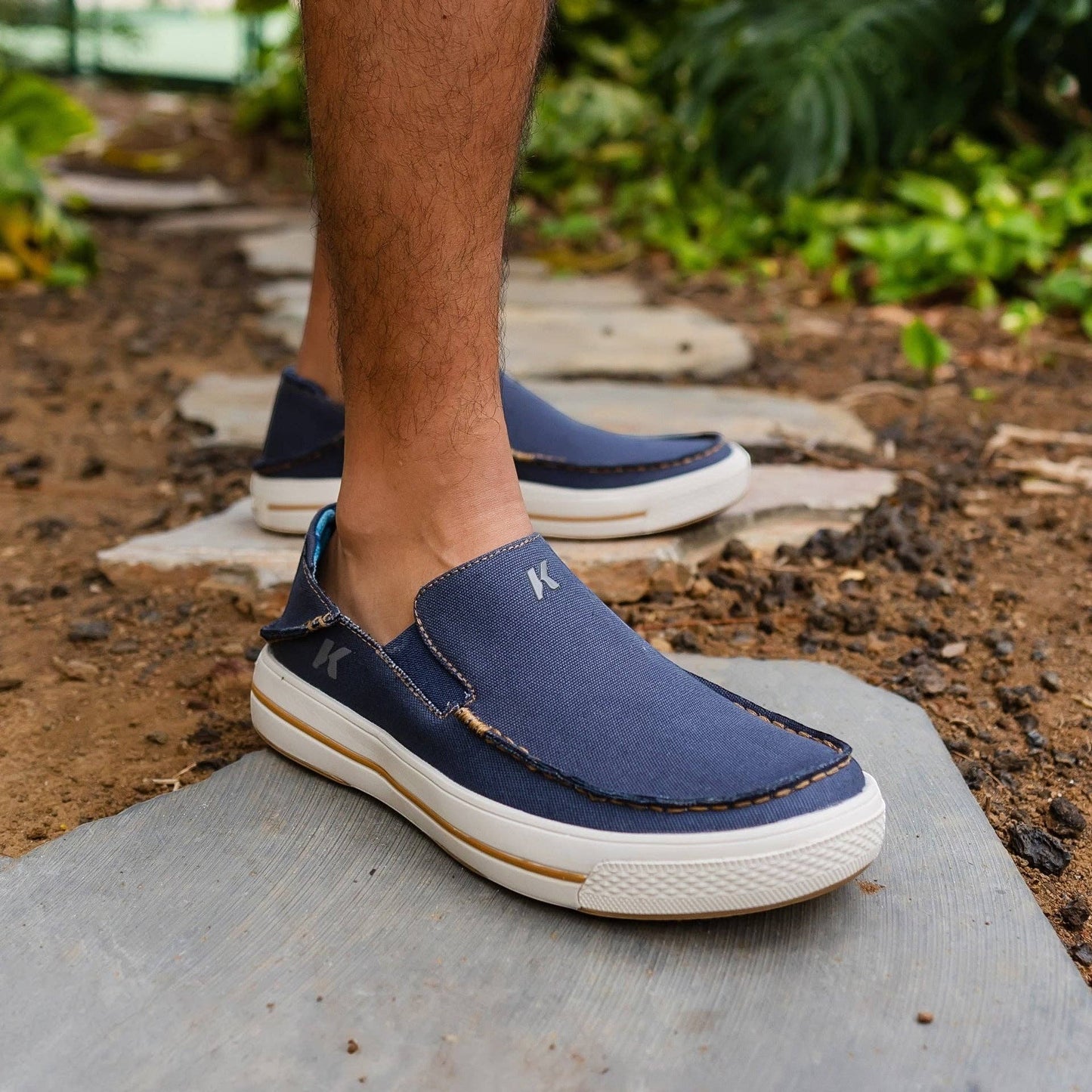 Allen's Bootery navy blue canvas slip-on boat shoes with contrast stitching and white soles.