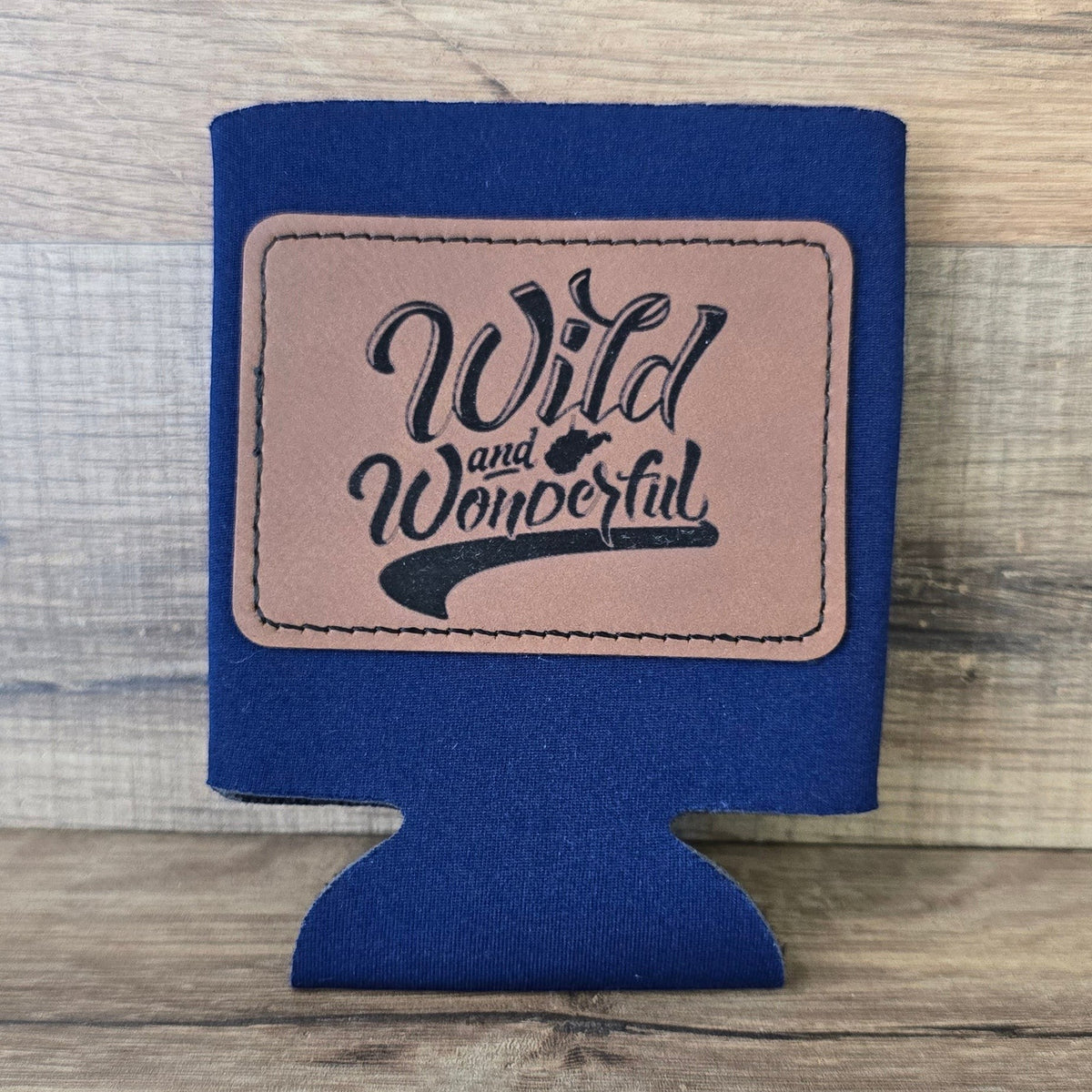 Allen's Bootery navy blue foam can koozie with a brown leather patch featuring Wild and Wonderful text