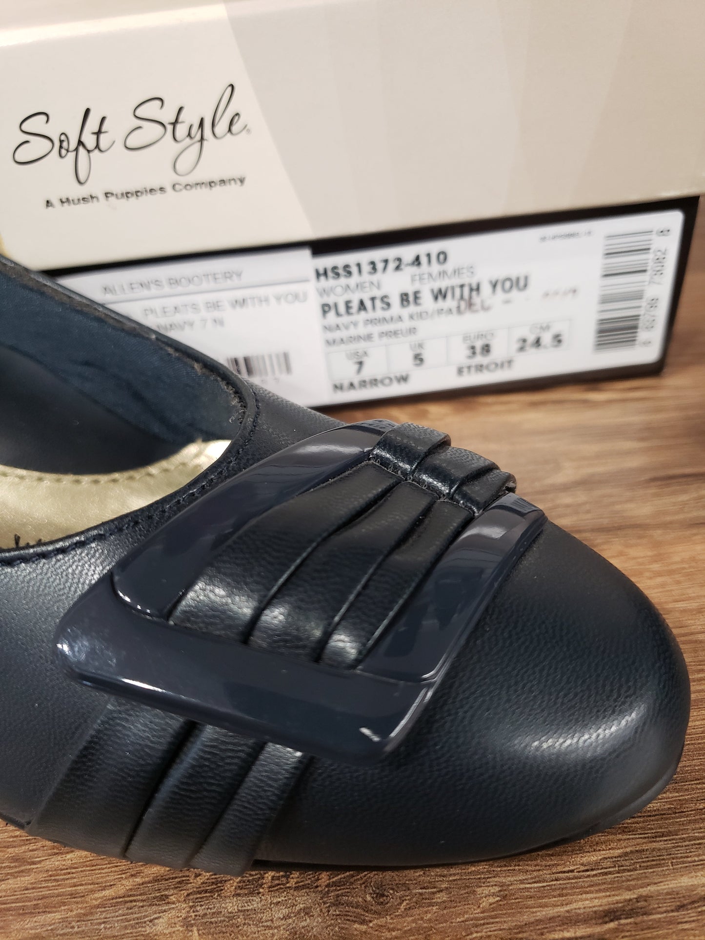 Allen's Bootery navy Pleats Be With You pump with a rounded toe, pleated patent buckle detail, and Soft Style box.
