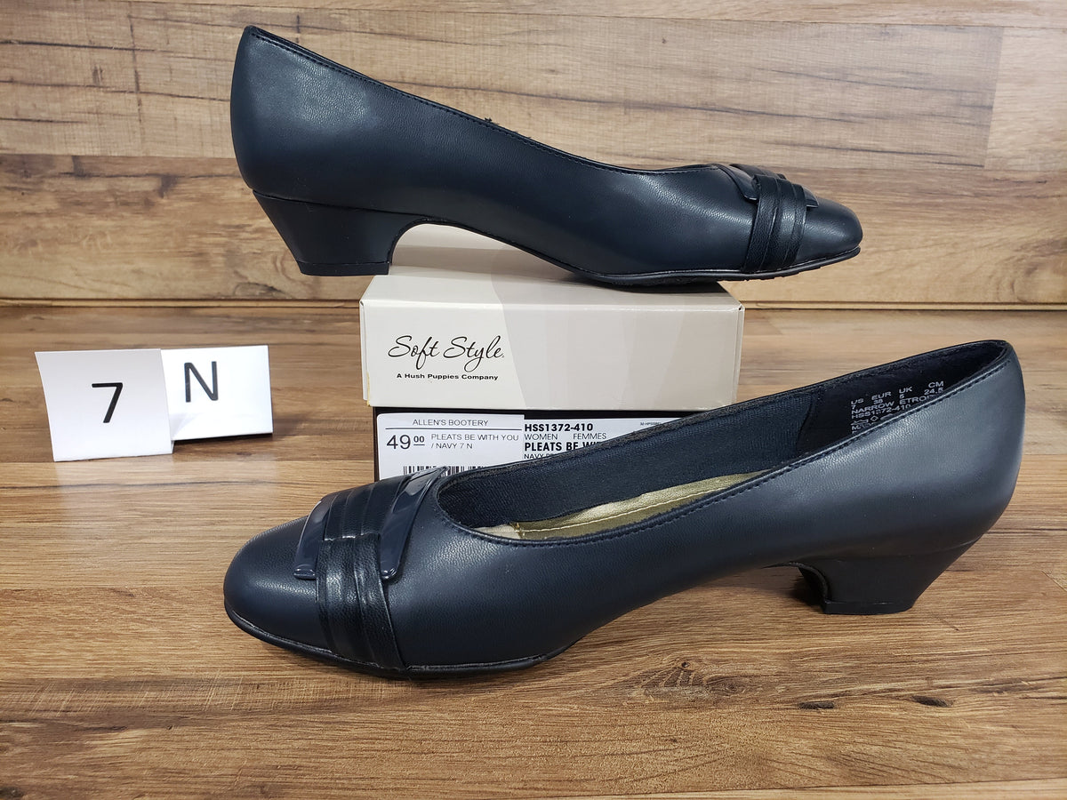 Allen's Bootery navy Pleats Be With You pumps with a rounded toe, buckle detail, and low heel on a wooden surface.