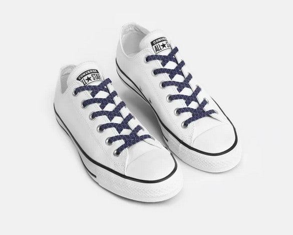 Allen's Bootery navy blue reflective Xpand no-tie elastic laces installed on white low-top canvas sneakers