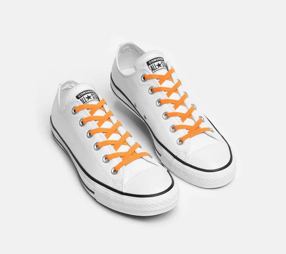 Allen's Bootery Xpand neon orange elastic no-tie laces installed on white low-top canvas sneakers