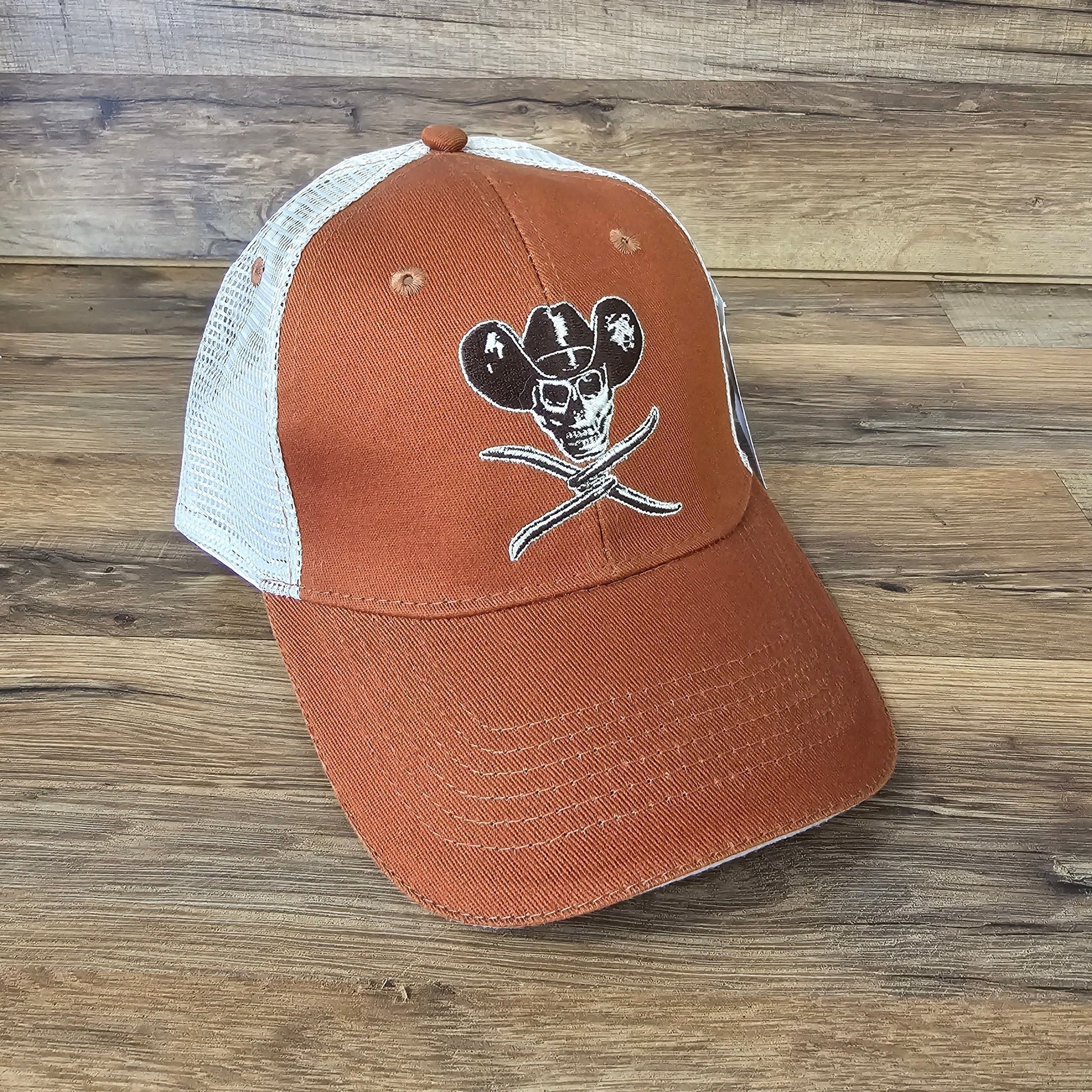 Allen's Bootery orange trucker hat with white mesh back and embroidered skull and cowboy hat graphic