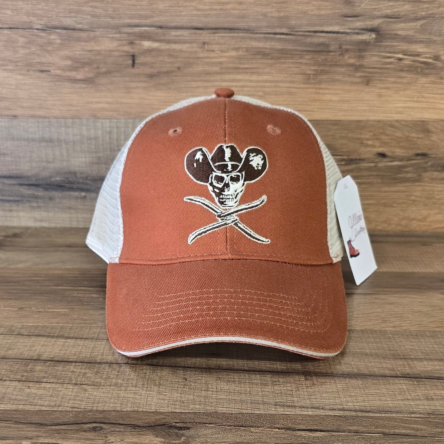 Allen's Bootery orange and white mesh trucker hat featuring an embroidered skull and cowboy hat graphic.