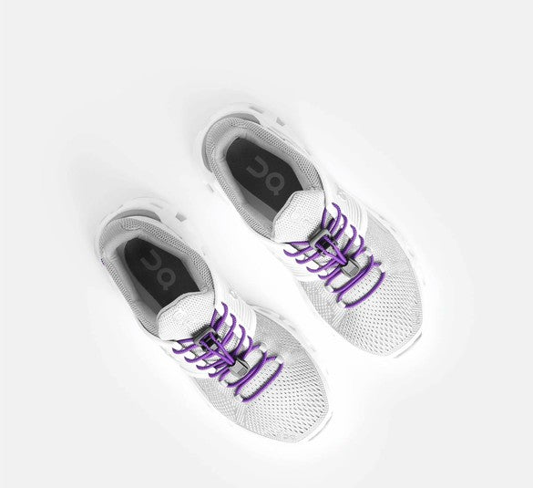 Allen's Bootery Xpand Laces quick release purple elastic laces installed on white athletic sneakers for a slip-on fit