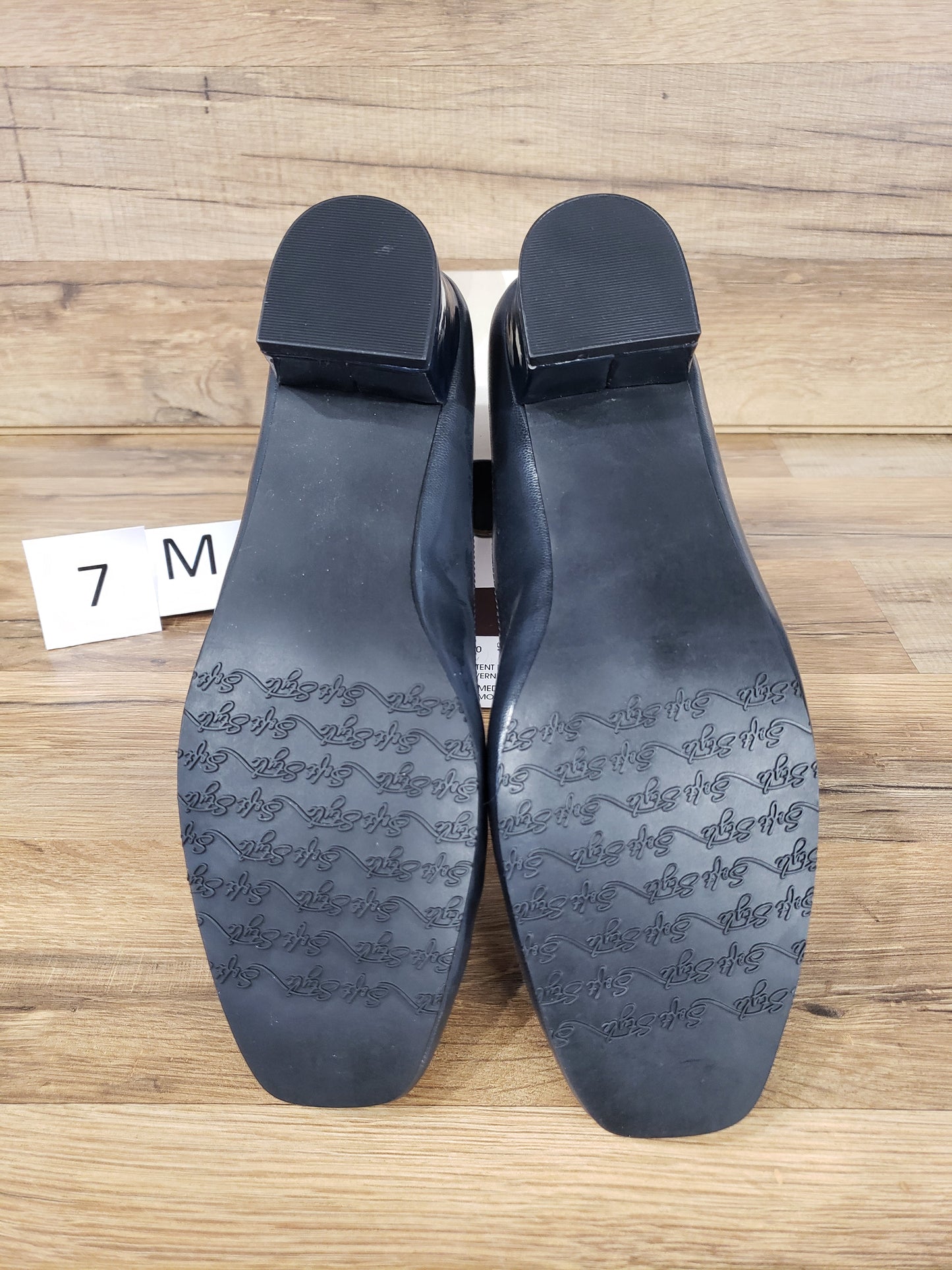 Allen's Bootery Santel navy cap toe pumps showing the textured rubber soles and low block heels
