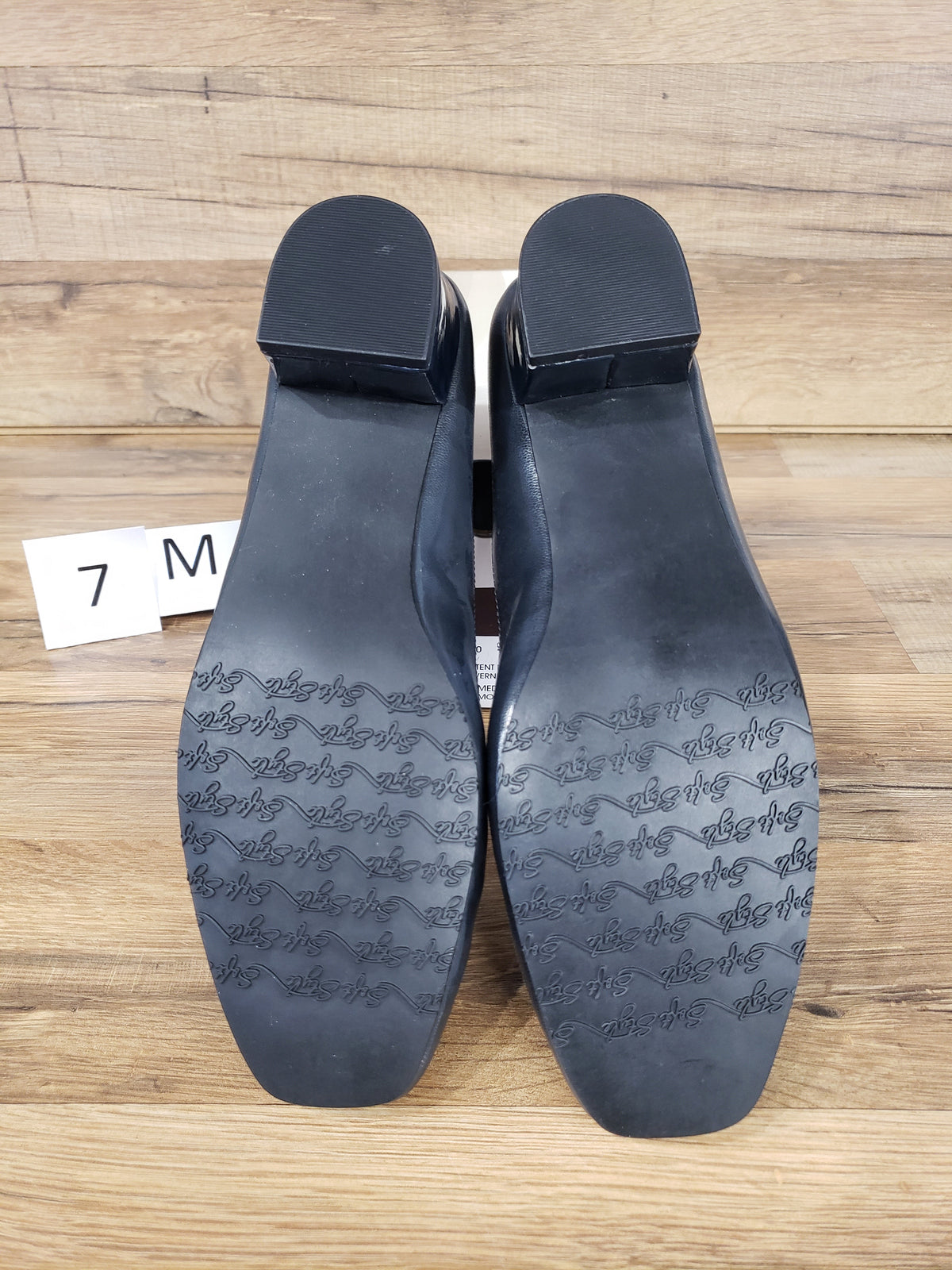 Allen's Bootery Santel navy cap toe pumps showing the textured rubber soles and low block heels