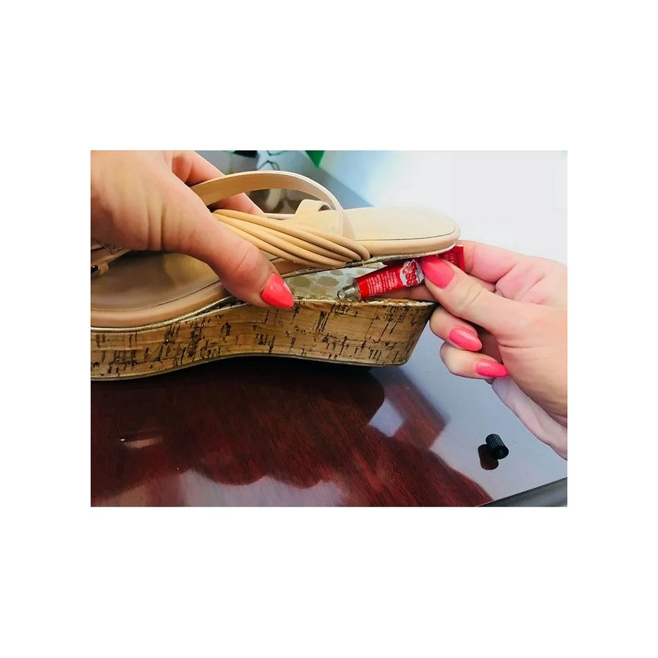 Allen's Bootery Shoe Goo Clear adhesive being applied to a wedge sandal sole for repair. Waterproof and flexible.
