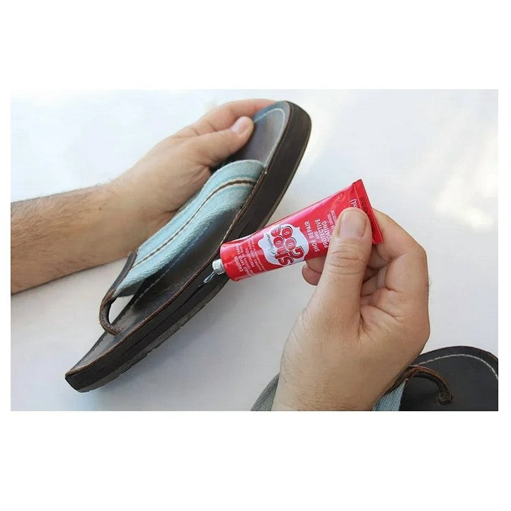 Allen's Bootery Shoe Goo Clear adhesive being applied to a sandal sole for repair. 3.7 oz tube.