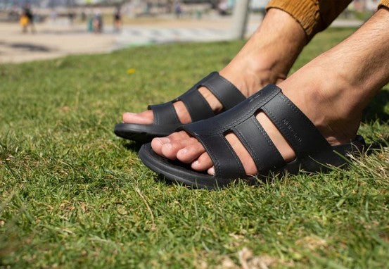 Allen's Bootery Stanley Slide Eclipse black EVA foam sandals worn on grass for comfortable outdoor summer wear
