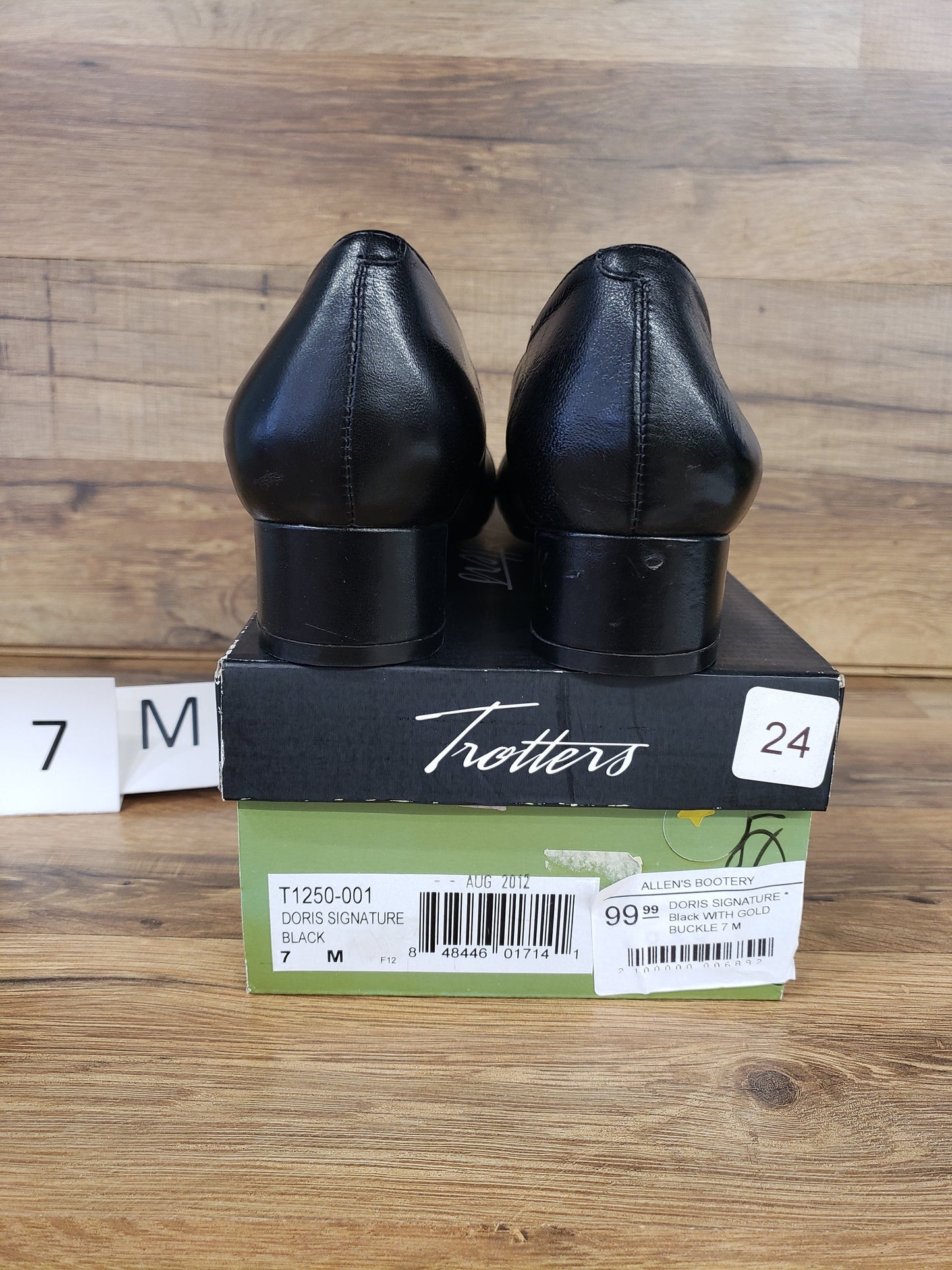 Allen's Bootery Trotters Doris Signature black dress shoes with low block heels, shown from the back on their box.