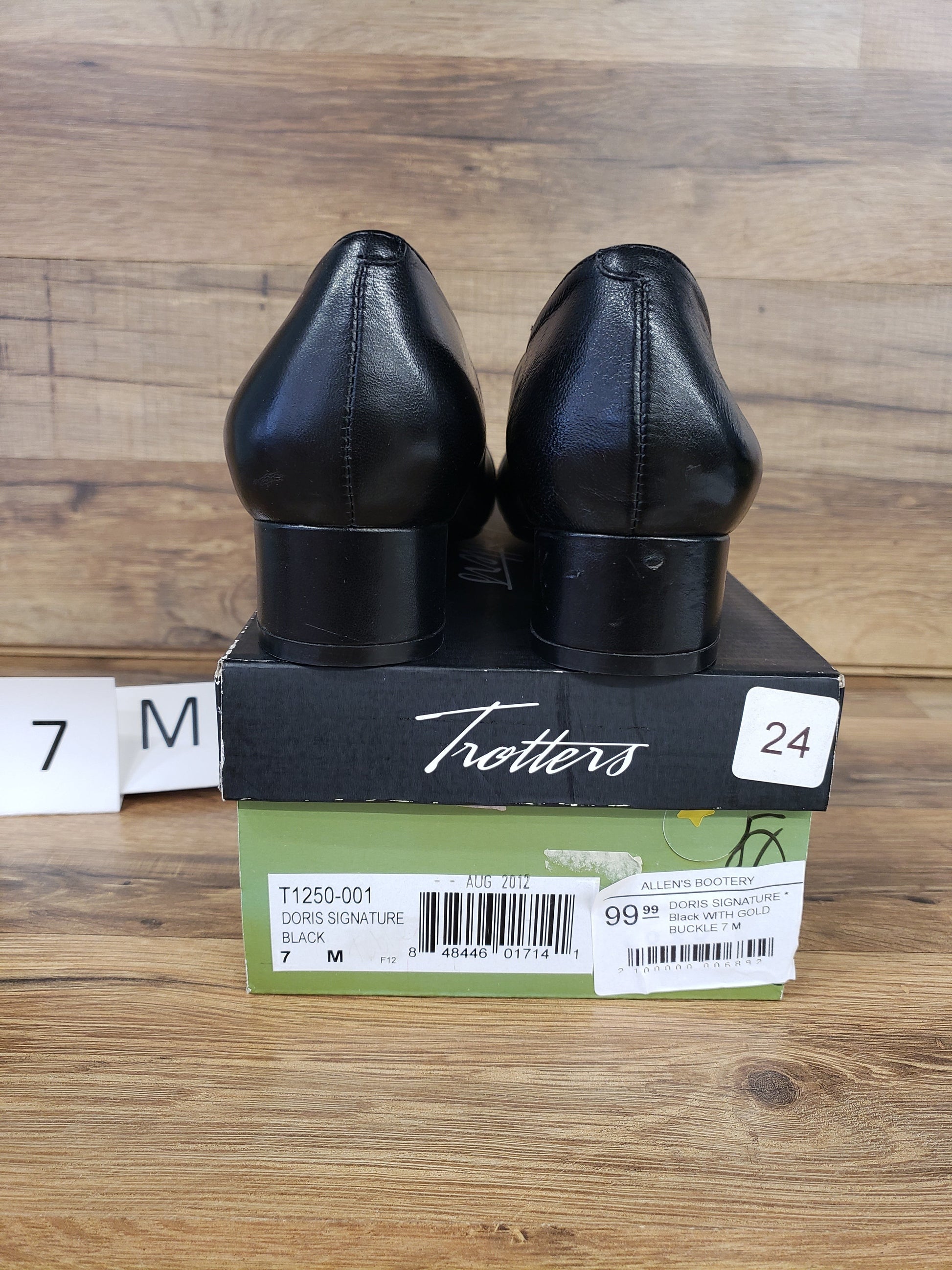 Allen's Bootery Trotters Doris Signature black dress shoes with low block heels, shown from the back on their box.