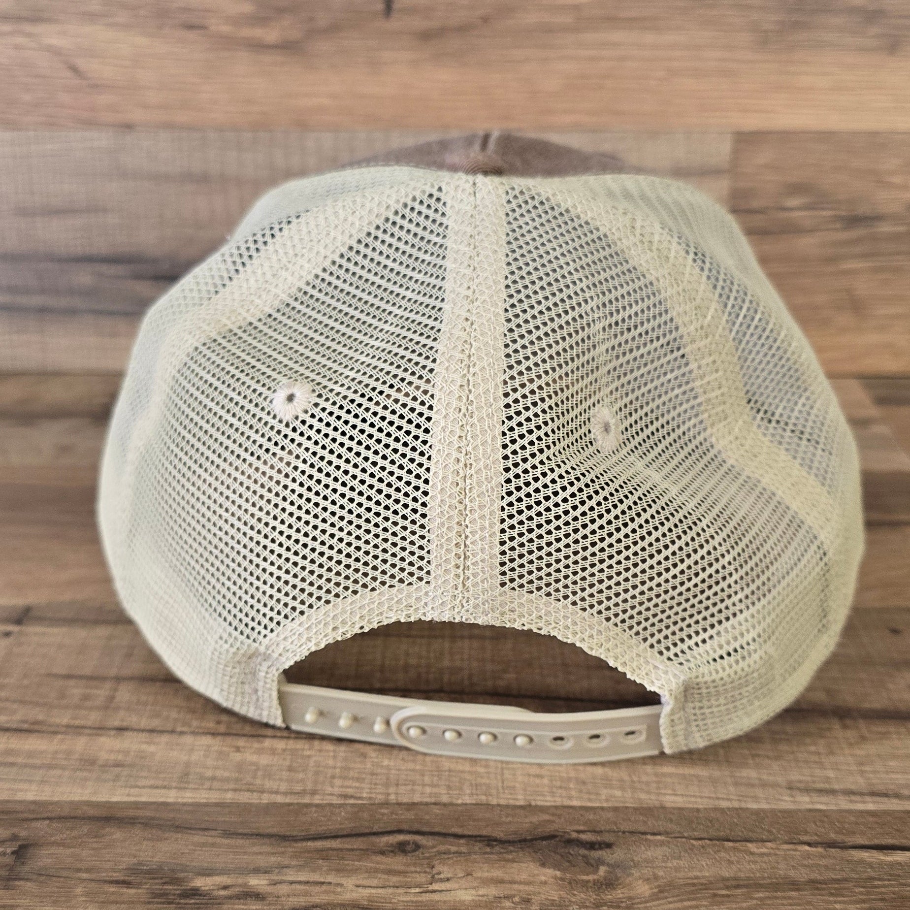 Back view of Allen's Bootery Mountain Mama trucker hat featuring a cream mesh back and adjustable snapback closure