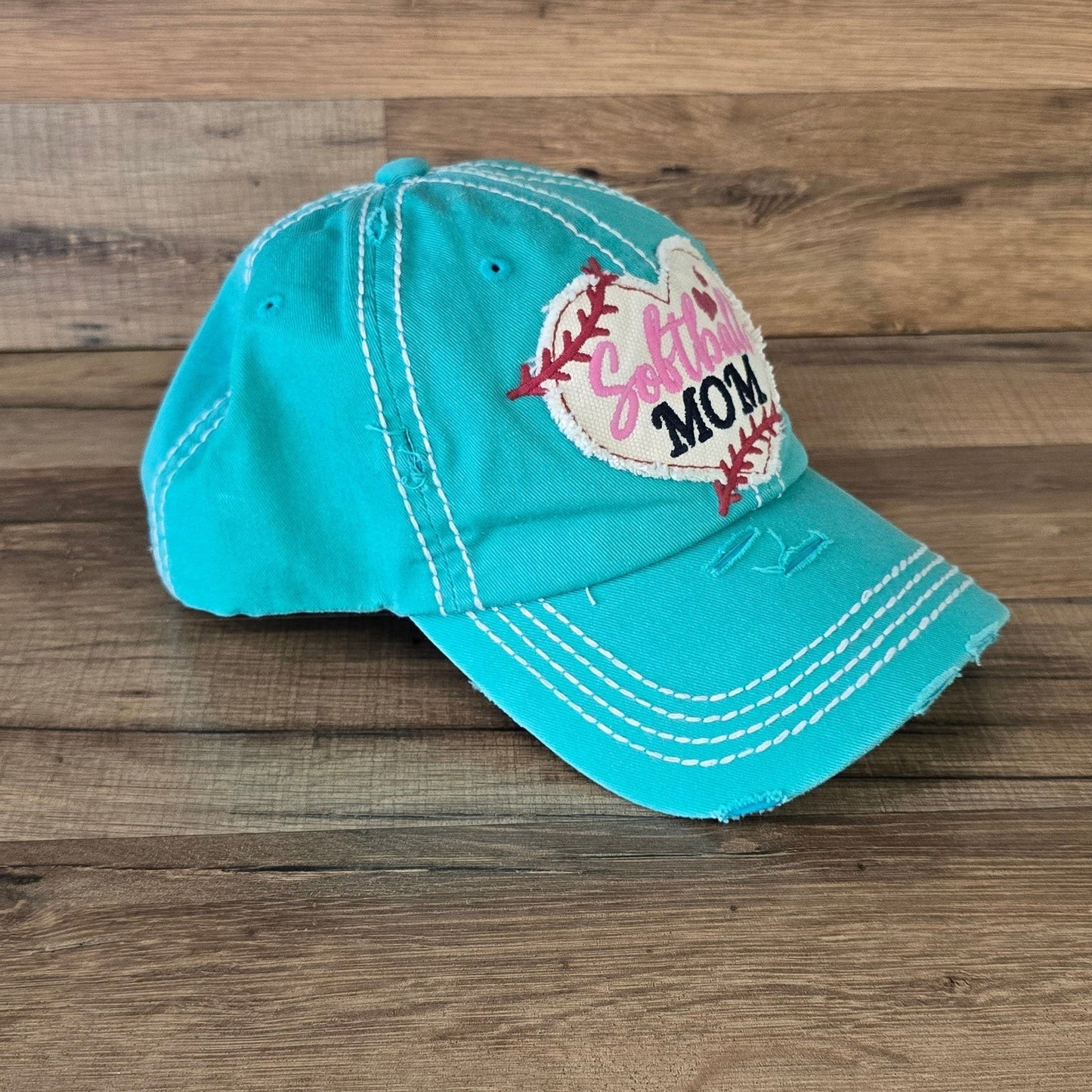 Allen's Bootery turquoise distressed cotton baseball cap with a heart-shaped softball embroidered patch for moms.