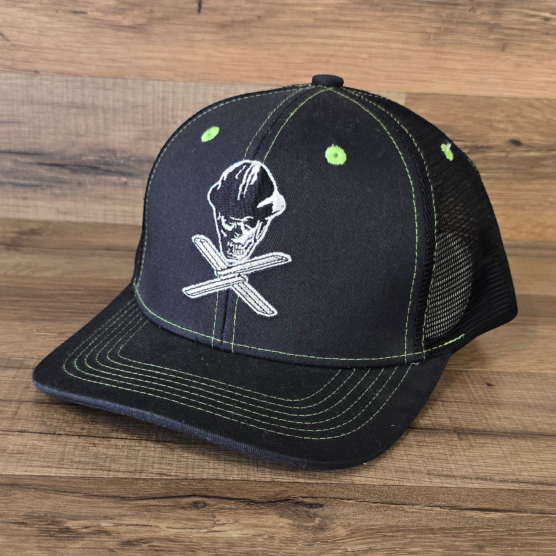 Allen's Bootery Twisted X black mesh hat with lime green stitching and skull and cross-tool embroidery