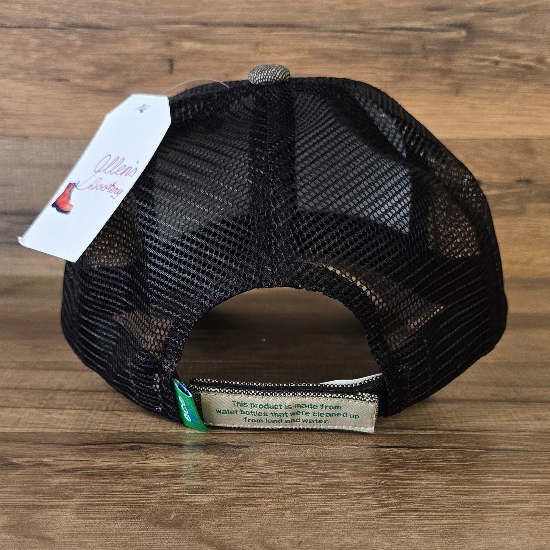Allen's Bootery Twisted X trucker hat with black mesh back and recycled material label on the hook and loop strap.