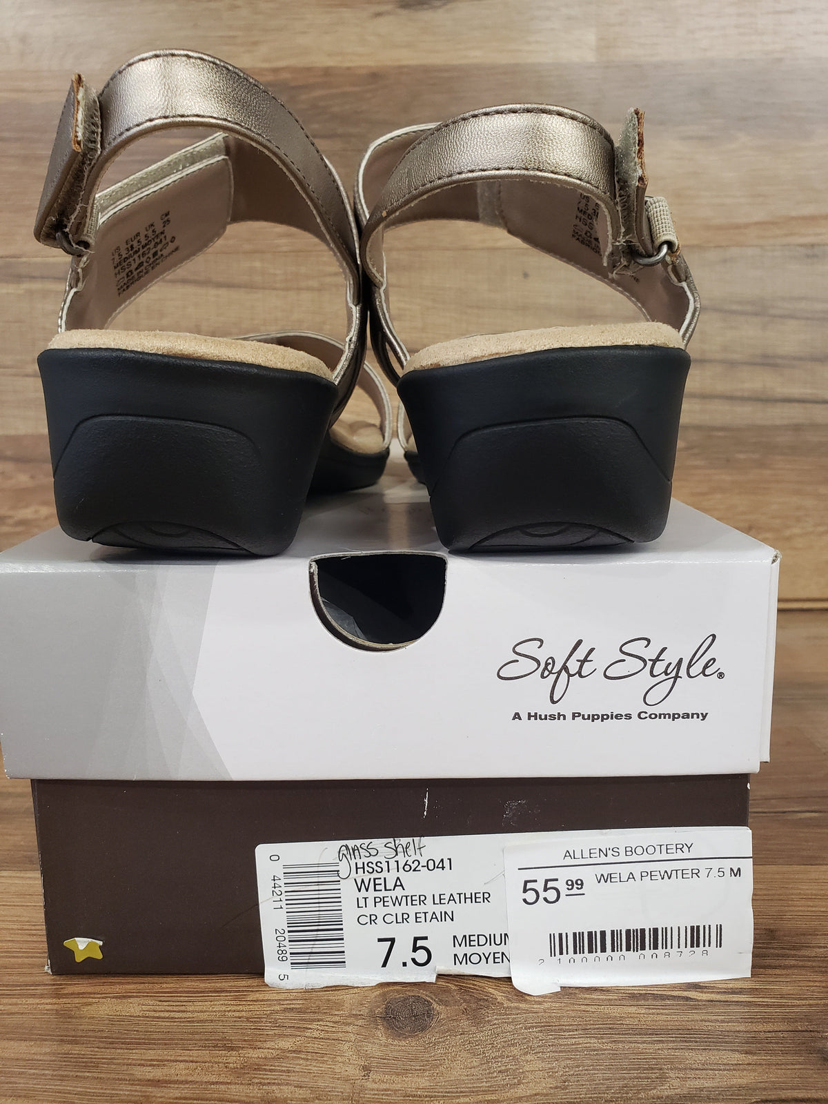Allen's Bootery Soft Style Wela pewter wedge sandals with velcro closure shown from the back on a shoe box