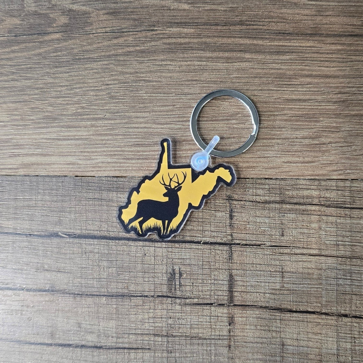 Allen's Bootery acrylic West Virginia state shaped keychain featuring a black deer silhouette on a yellow background.