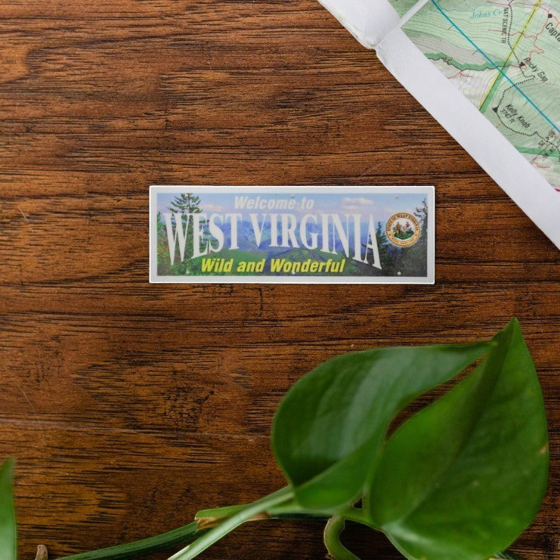 Allen's Bootery West Virginia interstate sign sticker with scenic mountain landscape on a wooden surface