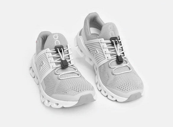 Allen's Bootery white reflective Xpand quick release elastic laces installed on grey mesh running shoes
