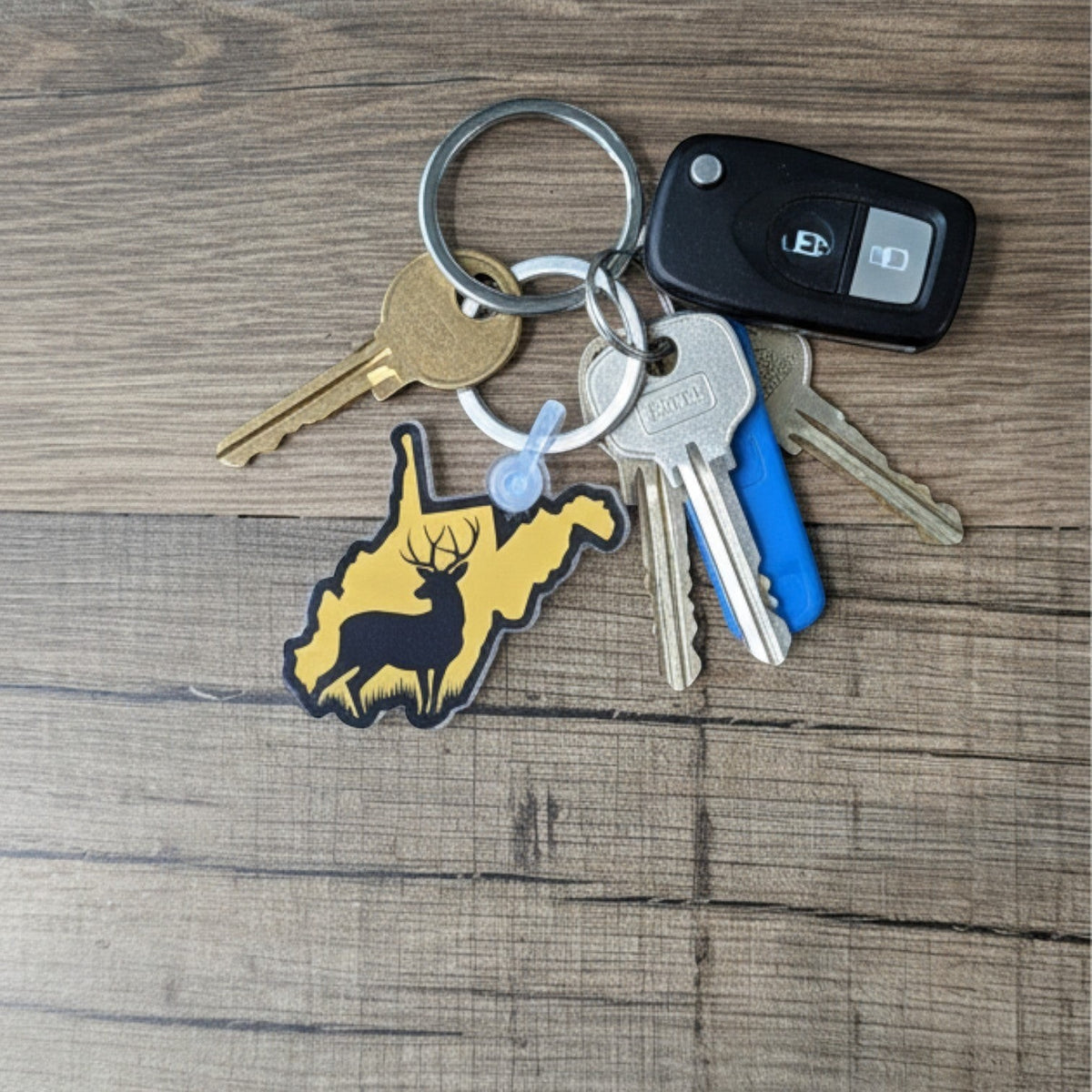 Allen's Bootery WV deer keychain featuring a yellow West Virginia state shape with a black deer silhouette