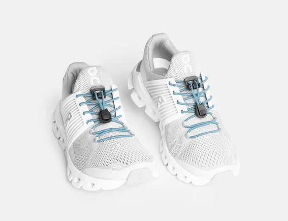 Allen's Bootery Xpand baby blue elastic quick release laces installed on white athletic sneakers