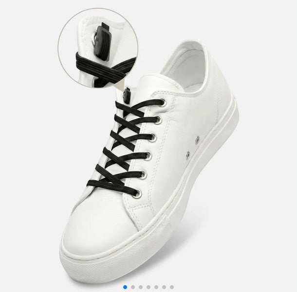 Allen's Bootery Xpand black elastic no-tie laces installed on a white leather sneaker with a close-up of the anchor