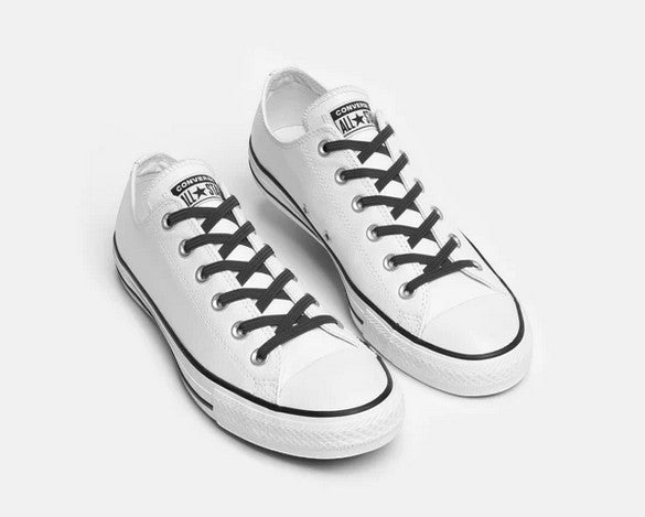 Allen's Bootery Xpand black elastic no-tie laces installed on a pair of white low-top canvas sneakers