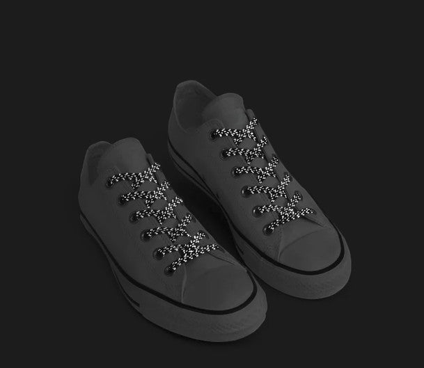 Allen's Bootery Xpand Laces Original black reflective no-tie elastic shoelaces installed on a pair of sneakers