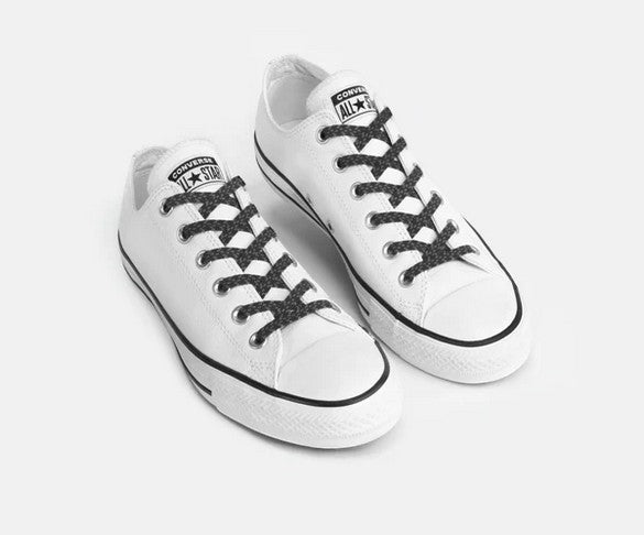 Allen's Bootery Xpand black reflective no-tie elastic laces installed on white low-top sneakers