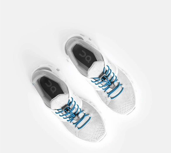 Allen's Bootery Xpand true blue elastic laces installed on white running shoes for a convenient slip-on fit.