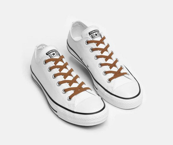 Allen's Bootery Xpand Laces Original brown no-tie elastic laces installed on white low-top sneakers