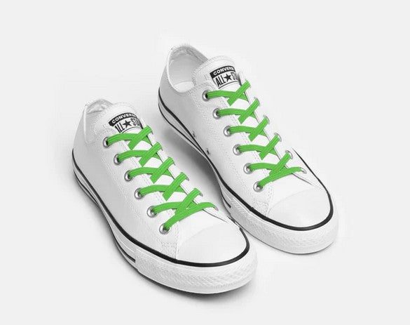 Allen's Bootery Xpand clover green elastic no-tie laces installed on white low-top sneakers