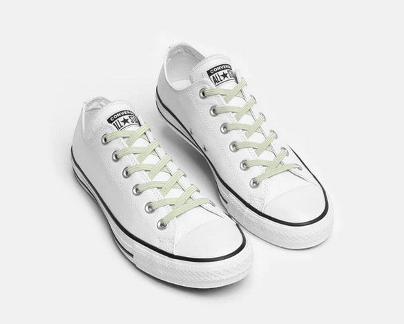 Allen's Bootery Xpand glow in the dark elastic no-tie laces installed on white low-top sneakers