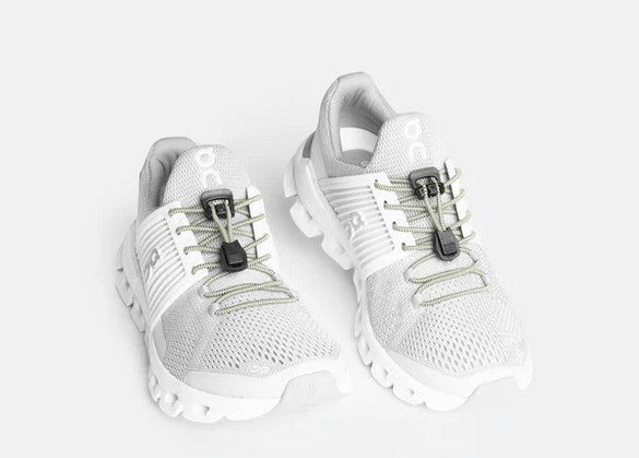 Allen's Bootery Xpand glow in the dark elastic quick release laces installed on white athletic sneakers