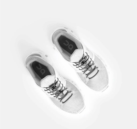Allen's Bootery Xpand gray elastic quick release laces installed on white running shoes, top-down view.
