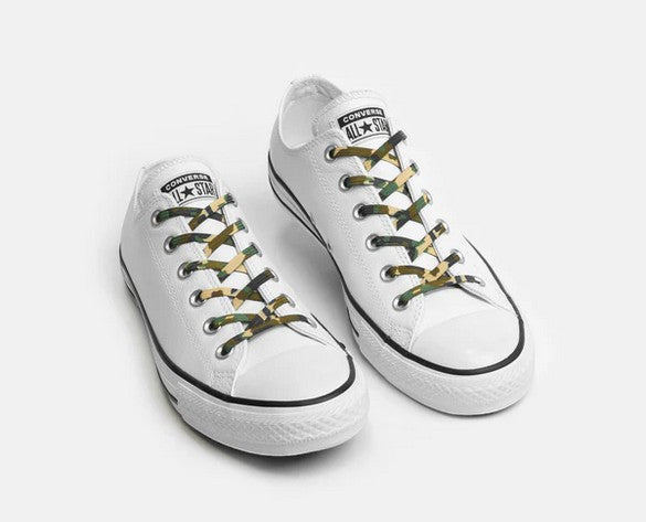Allen's Bootery Xpand Laces Original no-tie elastic shoelaces in green camo pattern on white low-top sneakers.