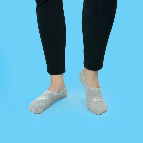 Allen's Bootery Xpand lightweight grey no-show socks with ergonomic cushioning worn on feet against a blue background